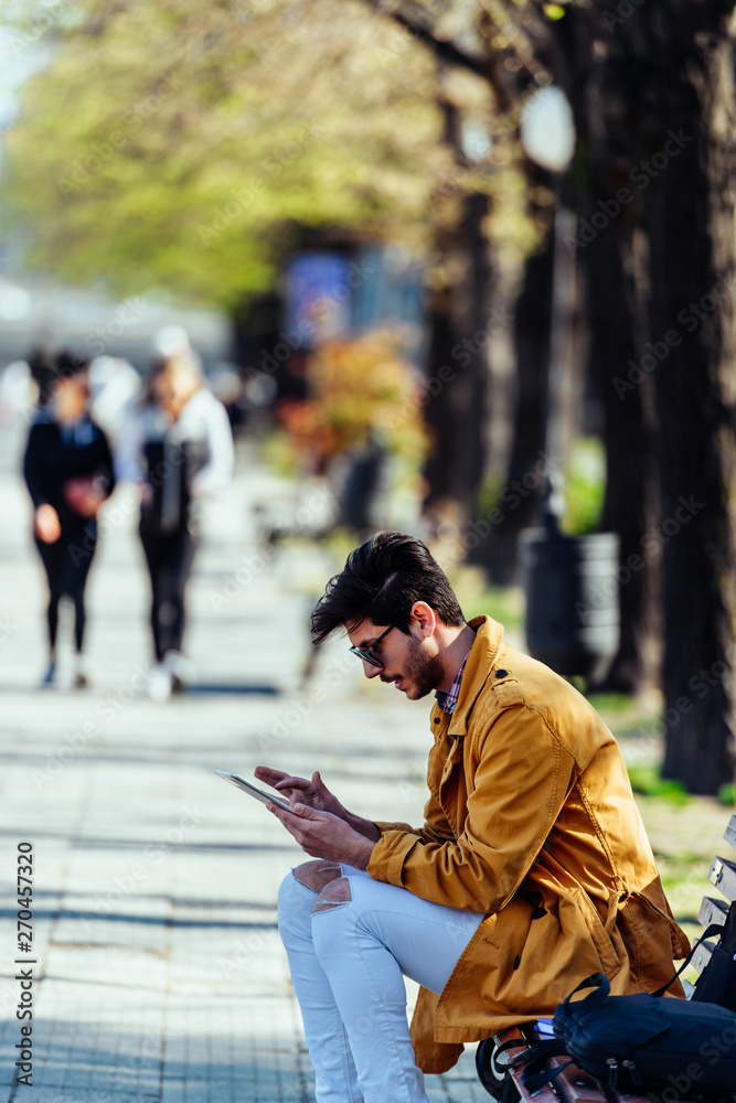 Fototapeta premium Urban businessman looking at his tablet