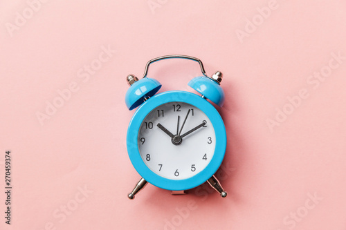 Ringing twin bell vintage classic alarm clock Isolated on pink pastel colorful trendy background. Rest hours time of life good morning night wake up awake concept. Flat lay top view copy space