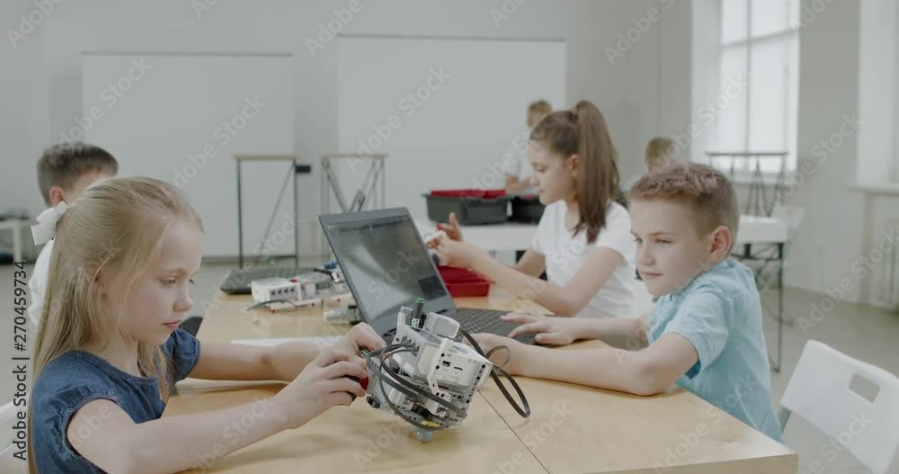 Curious kids working on a functional programable robot during robotics class at school. 4K UHD 60 FPS SLOW MOTION
