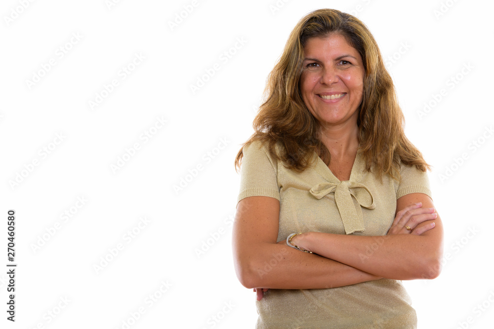 Studio shot of mature happy woman smiling with arms crossed Studio shot of mature happy woman smiling with arms crossed