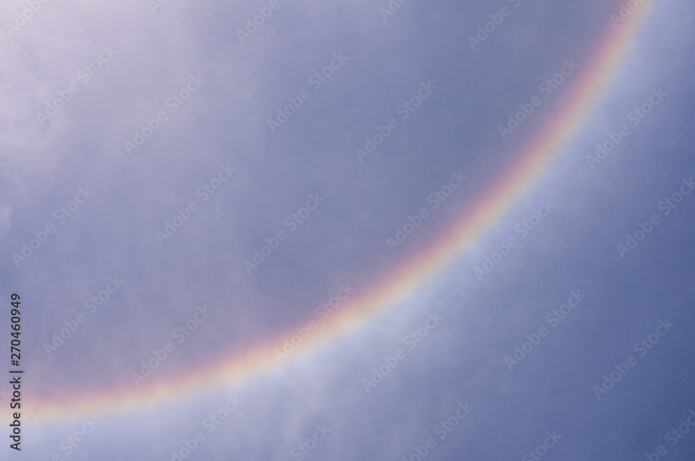 Part of sun halo Phenomenon in blue sky, circular rainbow.