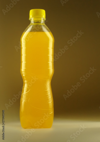  bottle with orange juice on a light brown background