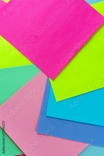Blue,pink,yellow,purple,green, neon paper color for background. Swirling kaleidoscopic geometric pattern of bright colors.