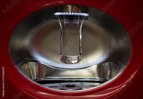 Close up of red soda dispenser