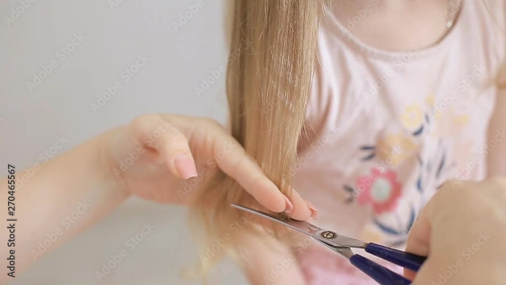 mom cuts her little daughter's hair mom cuts her little daughter's hair