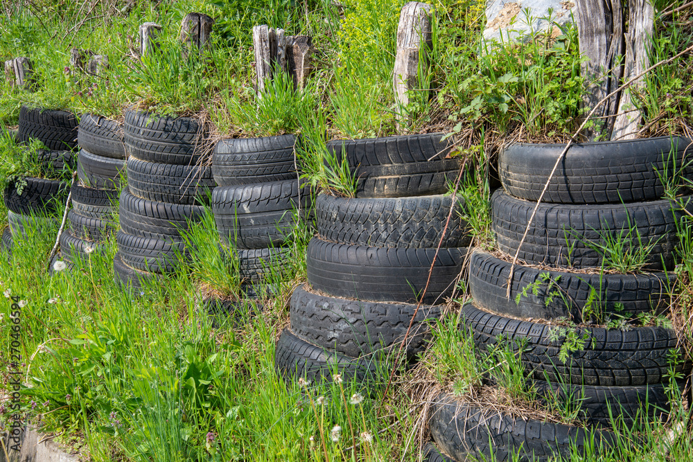 Wheels car as protection in nature. Car tires for shock and flood defense. Wheels car as protection in nature. Car tires for shock and flood defense.