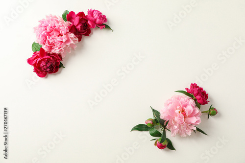 Flat lay composition with beautiful peonies on white background, space for text and top view © Atlas