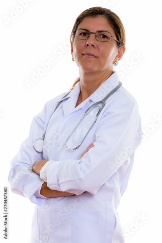 Studio shot of mature beautiful woman doctor with arms crossed