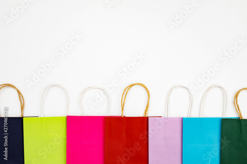 Set of different colour shopping paper bags on a white background, top view, flat