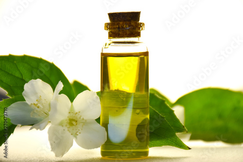 bottle of essential oil with flowers