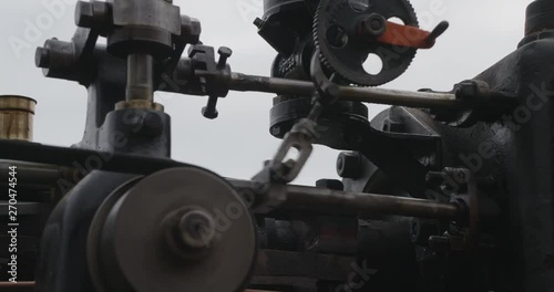 Flywheel spinning fast, beautiful steam tracktor.
