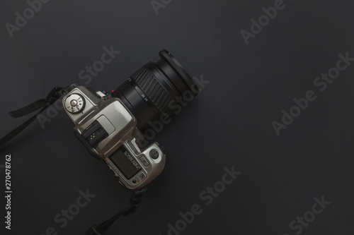 Photographer workplace with dslr camera system on dark black table background. Hobby travel photography concept. Flat lay top view copy space