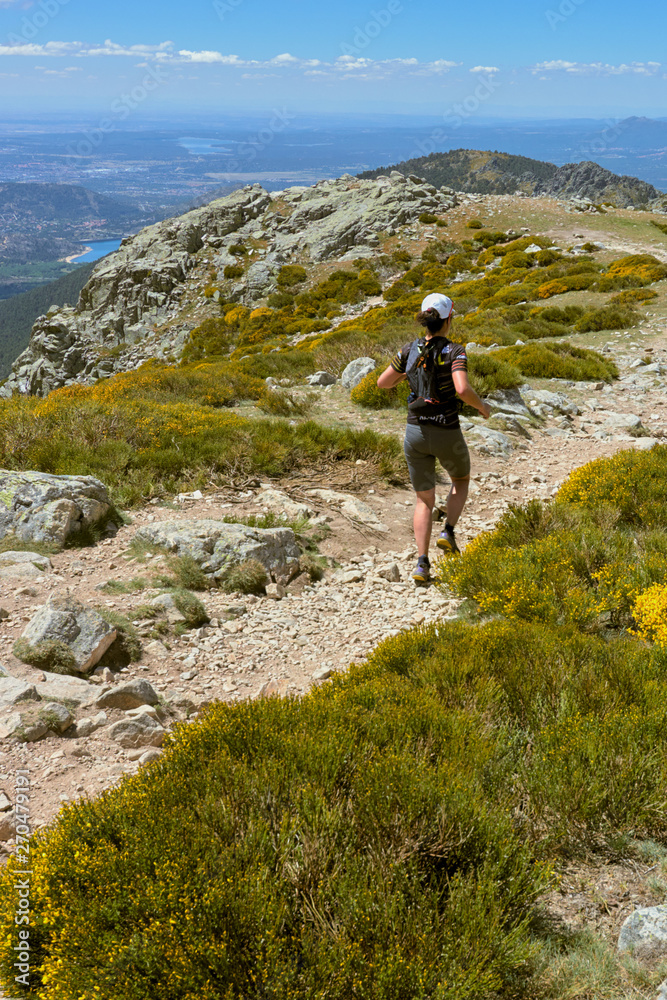 Young woman running in mountains on sunny spring day Young woman running in mountains on sunny spring day