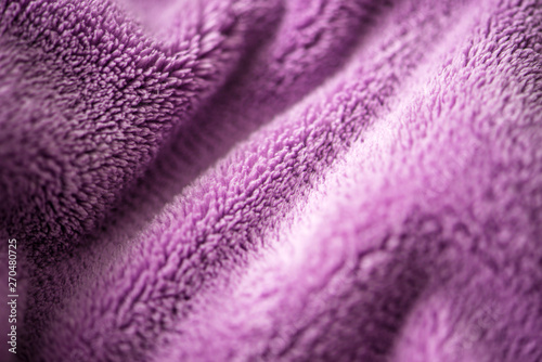 Lilac delicate soft background of fur plush smooth fabric. Texture of purple soft fleecy blanket textile