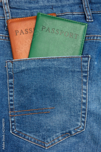 Close Up View to Passport Sticking Out From a Blue Jeans Pocket