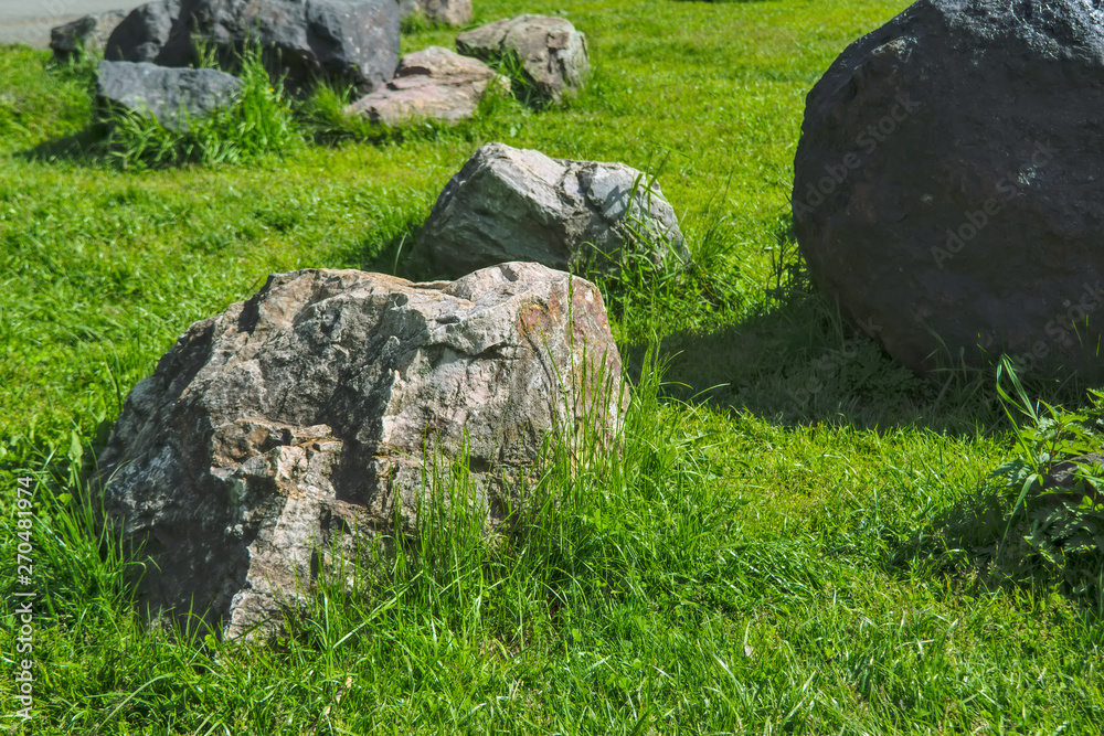 Garden of stones on the green lawn in the park. Garden of stones on the green lawn in the park.