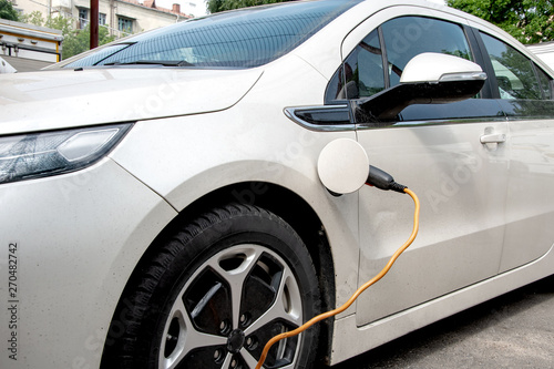 The electric car is charged from the mains, the cable from the charging station