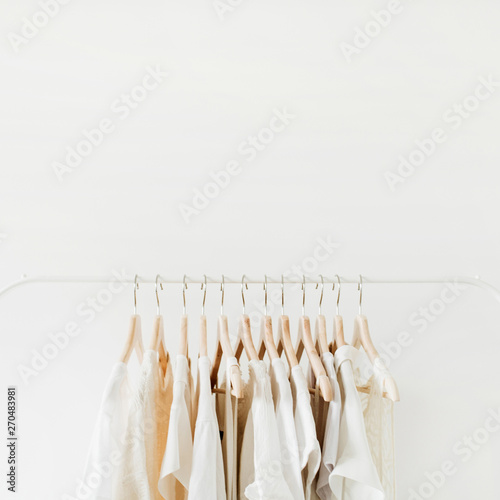 Minimal fashion clothes concept. Female blouses and t-shirts on hanger on white background. Fashion blog, website, social media hero header template. © Floral Deco