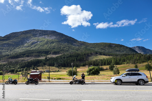 Wallpaper Mural Three motorcycles and car standing on roadside of highway in mountains of Norway. Travel in Scandinavia by vehicles Torontodigital.ca