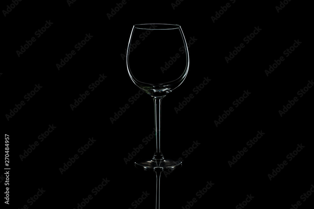 Wine glass on a black isolated background with reflection