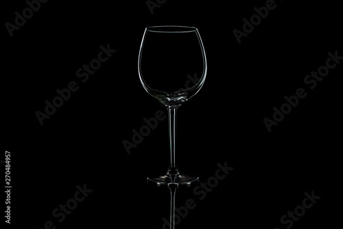 Wine glass on a black isolated background with reflection