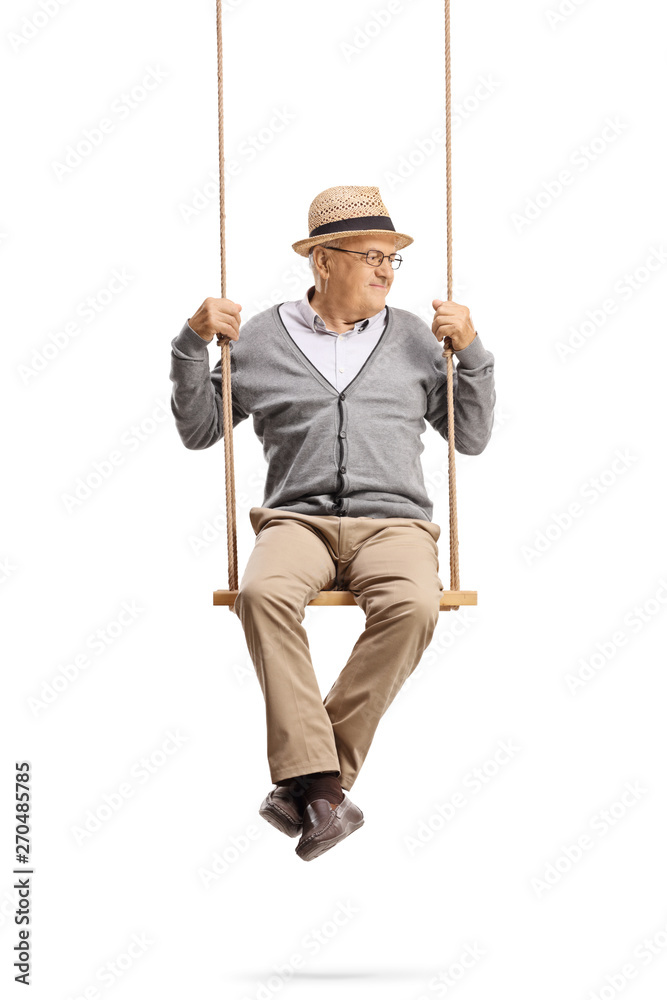 Mature gentleman sitting on a swing and looking to the side Mature gentleman sitting on a swing and looking to the side