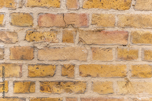 Brick wall with yellow, red and orange colors.