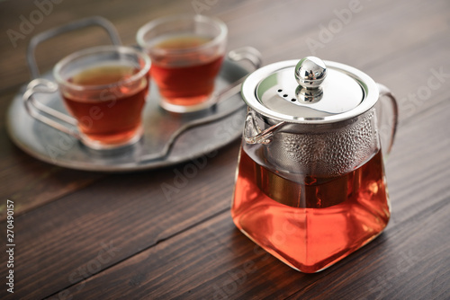 Two glass cup of tea with glass teapot