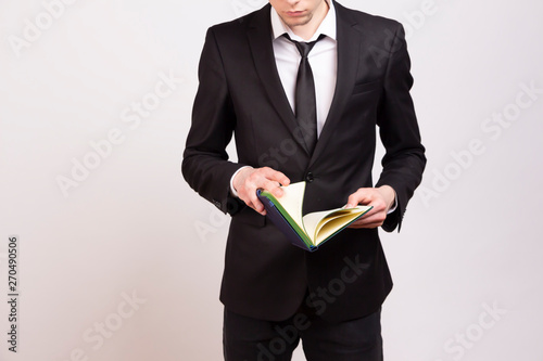  Man in suit with a notebook in hand