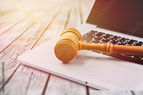 Close Up Of Wooden Brown Gavel On Laptop photo