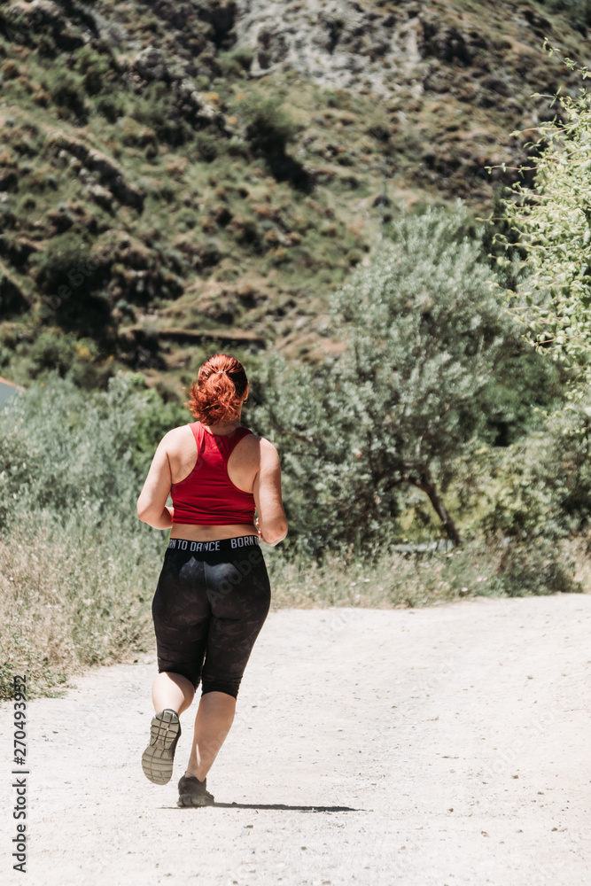 Active girl running at mountain, rural way Active girl running at mountain, rural way