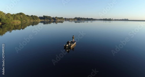 Aerial view of Fisherman fly fishing from a boat on the waterways of the Okavango Delta 