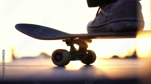Close up skateboard in sunset light, Venice Beach skate park, Los Angeles, California. Concept of healthy millennial active lifestyle, skateboarding & summer travel. Slow Motion. 