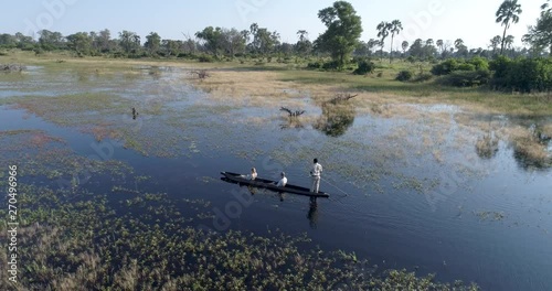 Aerial view of tourists enjoying a ride on a Mokoro - traditional canoe in the Okavango Delta photo