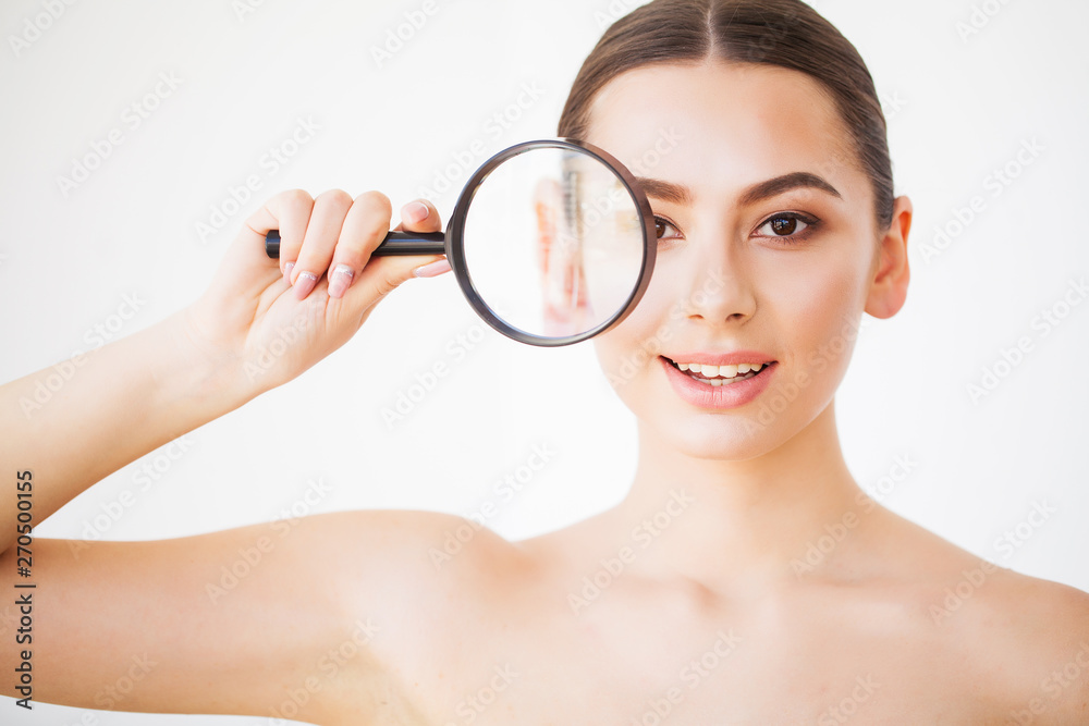 Woman Looking Through Magnifier And Smiling Close Up Woman Looking Through Magnifier And Smiling Close Up