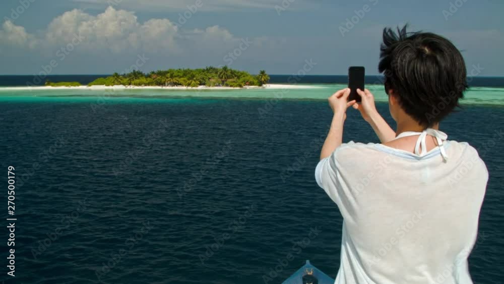Chinese tourist taking photography of tropical island Chinese tourist taking photography of tropical island