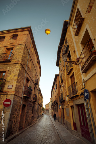 Narrow street in old town of Segovia  Flying balloon