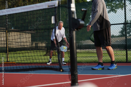 Pickleball is being played outside.