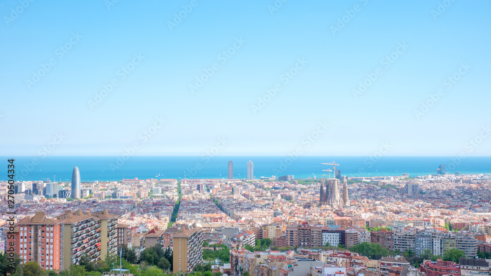 Barcelona city aerial view in Catalonia, Spain, cityscape with the Sagrada Familia at the middle far end.