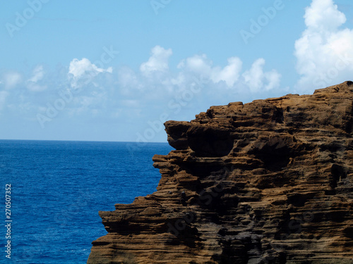 Lava Rock Cliff on coast with Pacific Ocean in distance