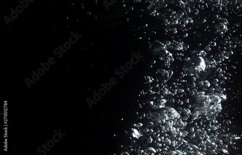 air bubbles water splash on black background.