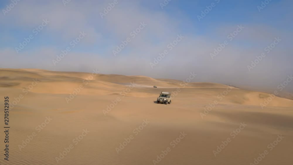 4K front view of 4x4 vehicles driving along the sand dunes of the Skeleton Coast, Namib desert, Namibia 4K front view of 4x4 vehicles driving along the sand dunes of the Skeleton Coast, Namib desert, Namibia