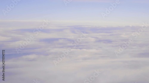 Passing by a field of misty white clouds on high altitude window view from cabin 2