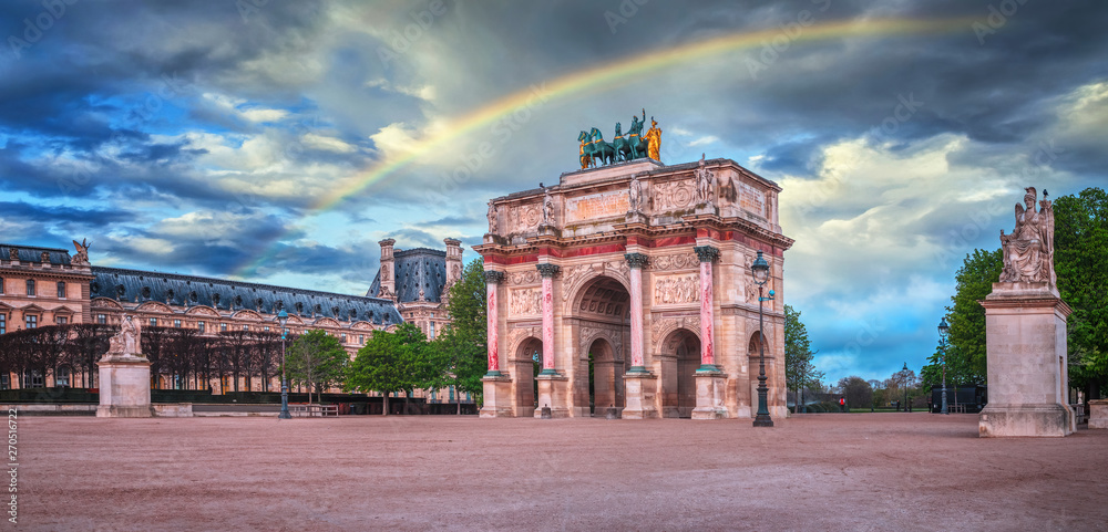Fototapeta premium Arc de Triomphe at the Place du Carrousel in Paris, France. Rainbow in the sky.