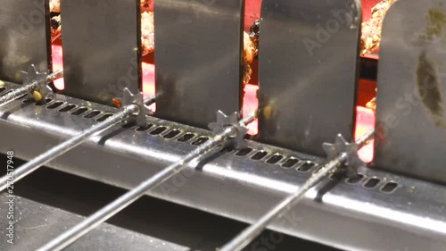 Grilling Meat in Automatic Grill Machine photo