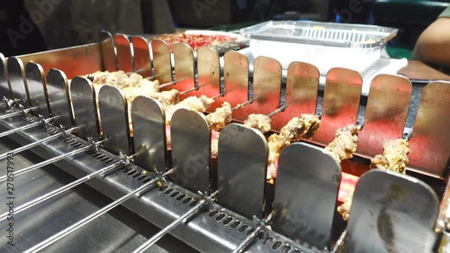 Grilling Meat in Automatic Grill Machine photo