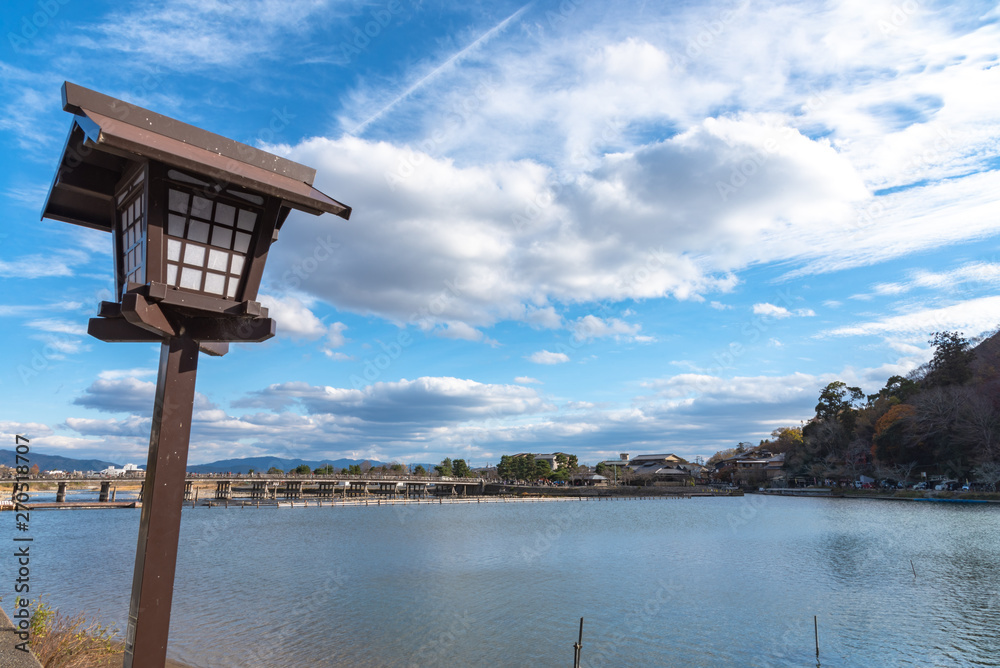 Togetsu-kyo bridge over katsuragawa river with colourful forest mountain background in Arashiyama district. Arashiyama is a nationally designated Historic Site and Place of Scenic Beauty. Kyoto, Japan