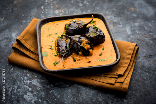 Baingan masala / Eggplant / brinjal curry served in bowl or pan, selective focus photo