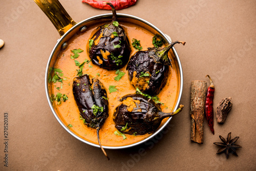 Baingan masala / Eggplant / brinjal curry served in bowl or pan, selective focus photo