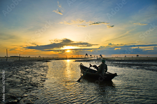 Sunrise over clam farms on Dong Chau beach, Thai Binh, Vietnam